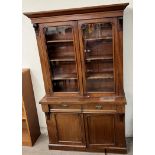 A Victorian mahogany bookcase with a moulded cornice above a pair of glazed doors,