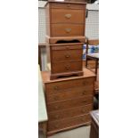 A modern teak effect chest of drawers together with a matching pair of bedside chests