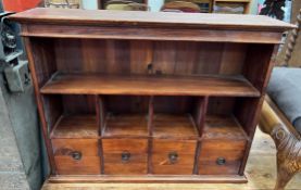 A table top cabinet with a moulded cornice above a shelf and four compartments and four drawers,