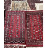 Two Turkoman rugs with red ground and multiple guls together with a Belgian rug