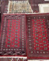 Two Turkoman rugs with red ground and multiple guls together with a Belgian rug