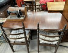 A mid 20th century Ercol dining table together with a set of four ladder back chairs and a Singer