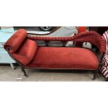 An Edwardian upholstered chaise longue with a pad upholstered back and seats on shaped legs