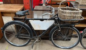 A Raleigh Tradesman's carrier bicycle with a carrier in the front, advertising panel,