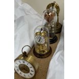 Two anniversary clocks together with another clock and a glass hot air balloon