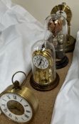 Two anniversary clocks together with another clock and a glass hot air balloon