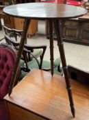 A Victorian walnut occasional table with a circular top on three faux bamboo legs,