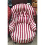 A Victorian nursing chair with a striped fabric on turned legs and casters together with a walnut