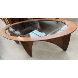 A G-Plan teak coffee table of oval form with an inset glass panel