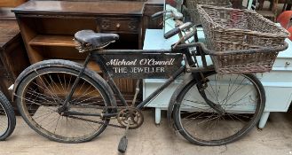 A Raleigh Tradesman's carrier bicycle with a carrier in the front,