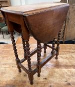 A small oak gateleg table with an oval top and drop flaps on barley twist legs and pad feet