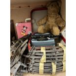 A Junior typewriter together with a teddy bear,