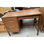 A mid 20th century teak desk with a rectangular top above three drawers on square legs