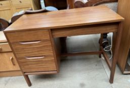 A mid 20th century teak desk with a rectangular top above three drawers on square legs