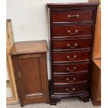 An Edwardian walnut pot cupboard with a rectangular top above a single panelled door on bracket