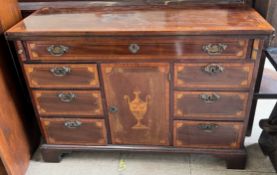 A 20th century mahogany side cabinet with a fold over top with drawers and a central cupboard