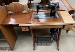 A Singer sewing machine set in a table with treadle pedal