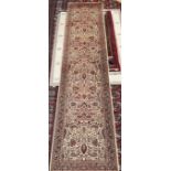 A wool runner with a cream ground and multiple flower heads,