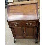 A 20th century mahogany Kilkenny Woodworkers bureau with a sloping fall,