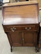 A 20th century mahogany Kilkenny Woodworkers bureau with a sloping fall,