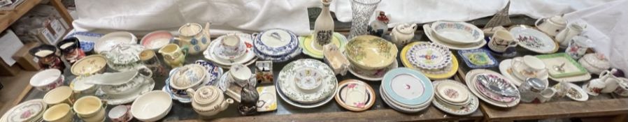 A large lot including various plates, tea pots, toby jugs, glass vase,