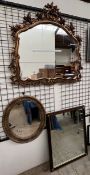 A large gilt wall mirror with foliate decoration to the top and sides together with an oval gilt