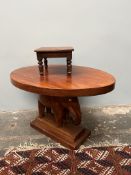 An occasional table of oval form supported by an elephant together with a small table
