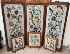 A large embroidered three fold screen / room divider decorated with flowers and leaves together