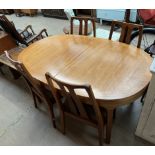 A Nathan teak dining suite comprising an extending dining table, four chairs,