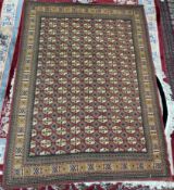 A rug with a red ground and multiple guls,