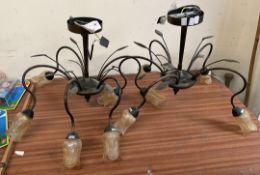 A pair of five light chandeliers with glass flowerhead shades