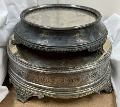 An electroplated cake stand of large circular form with a polished top on scrolling feet together