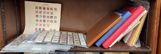 A collection of loose stamps, stamp albums,