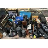 A Yashica Mat camera together with other cameras and a collection of camera lenses and accessories