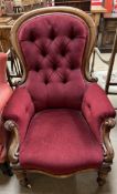 A Victorian mahogany framed gentleman's chair with a button back upholstered spoon back with pad