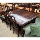 An Edwardian mahogany extending dining table on turned legs and casters together with a set of six