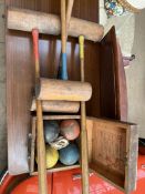 A partial croquet set with mallets and balls