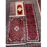 A red ground runner with geometric decoration to cream and red guard stripes,
