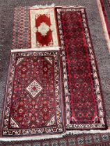 A red ground runner with geometric decoration to cream and red guard stripes,