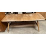 An Ercol light elm coffee table with a rectangular top on tapering legs
