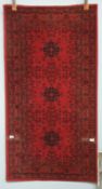 A wool pile Afghan rug,