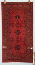 A wool pile Afghan rug,