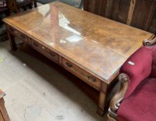 A reproduction walnut coffee table, with a rectangular top with a protective glass sheet,