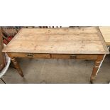 A pine and oak library type table with a rectangular top above two drawers on turned legs