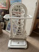 A Victorian cast iron umbrella stand painted white,