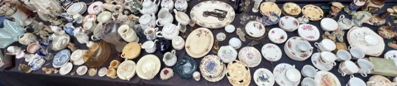 An extensive lot including a Poole pottery dolphin, part tea services, vases, dolls, teapots,