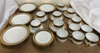 A continental porcelain part tea and dinner set decorated with a gilt and blue line border