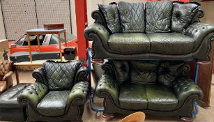 A green leather four piece suite comprising a three seater settee, two seater settee,