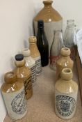 A collection of stoneware Ginger Beer bottles together with other bottles etc