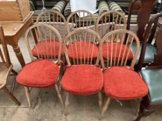 A set of six stick back dining chairs with solid seats on turned legs